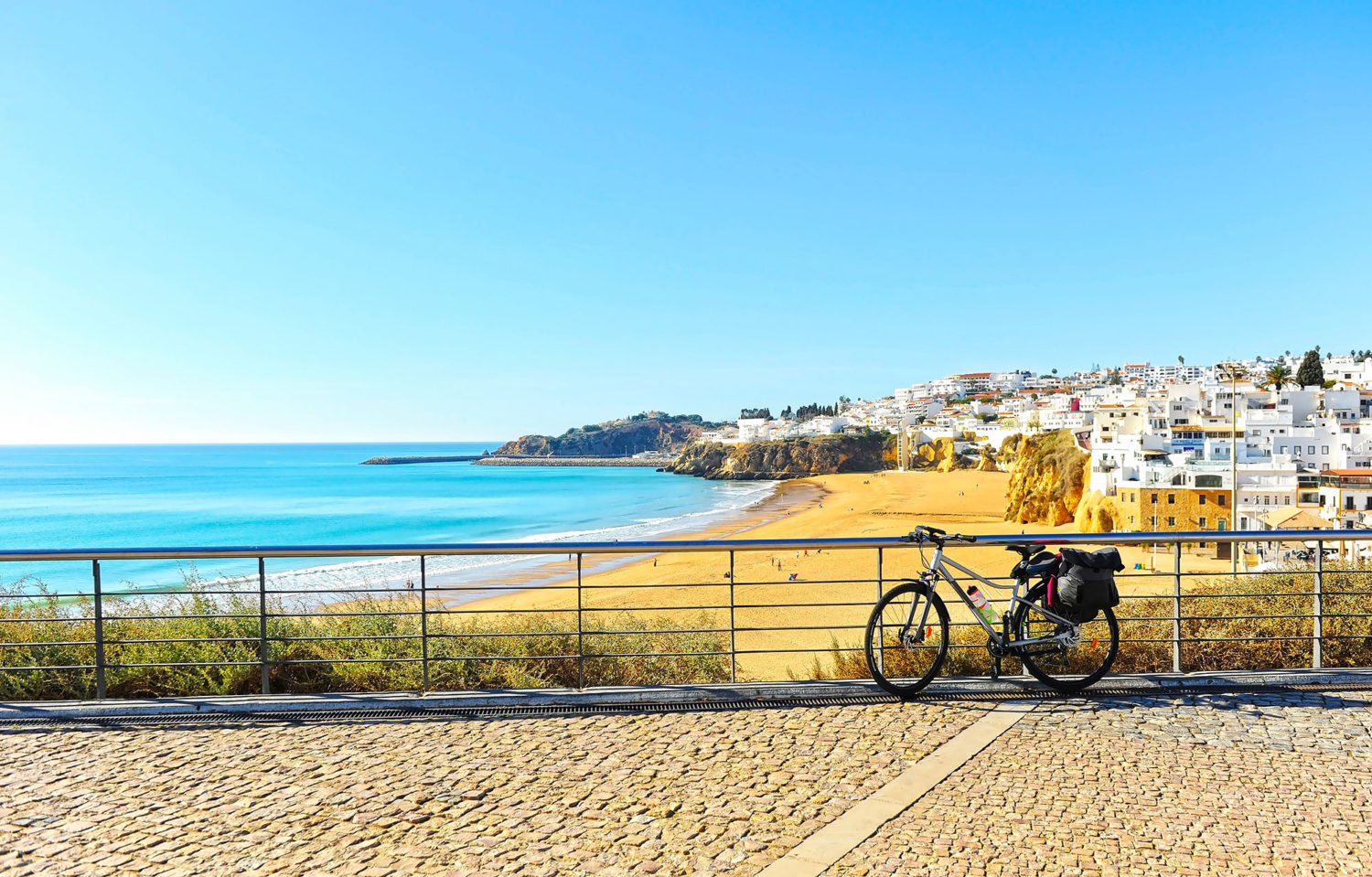 Bicycle near a sandy beach and a seaside town in Portugal